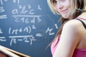 9808019-pretty-young-college-student-writing-on-the-chalkboard-blackboard-during-a-math-class-shallow-dof-co