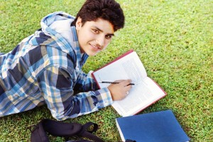 http://www.dreamstime.com/royalty-free-stock-images-college-student-reading-over-grass-image28690289